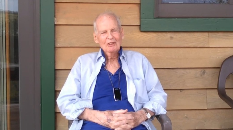 Nicholas Pryor talking in a blue shirt