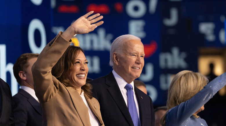 Kamala Harris smiling and waving next to Joe Biden