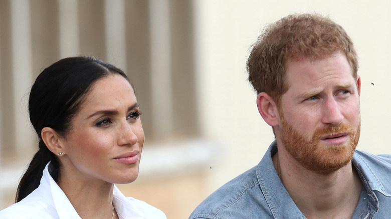 Prince Harry and Meghan Markle listening