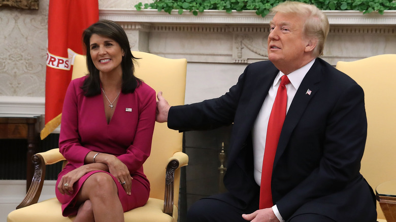 Donald Trump with a hand on Nikki Haley's shoulder