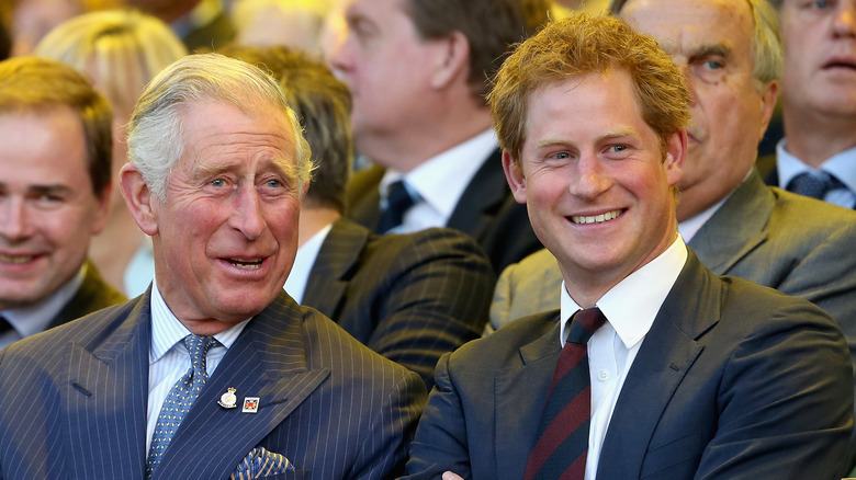 Prince Charles at an event with son Prince Harry. 