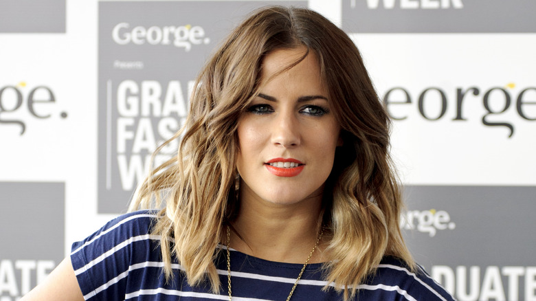 Caroline Flack posing at event