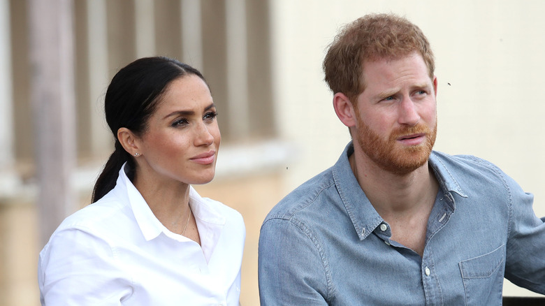 Prince Harry and wife Meghan Markle pose together. 