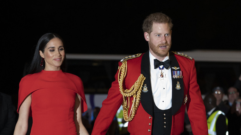 Prince Harry and Meghan Markle attend an event. 