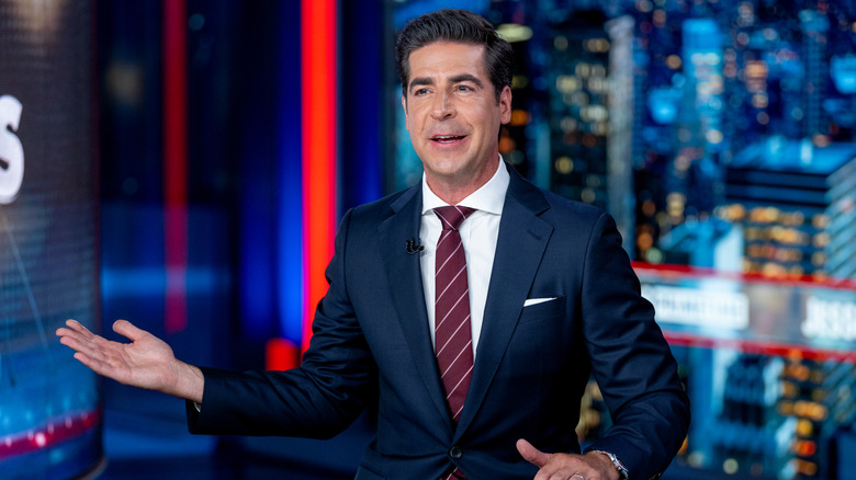 Jesse Watters hand raised, on television set