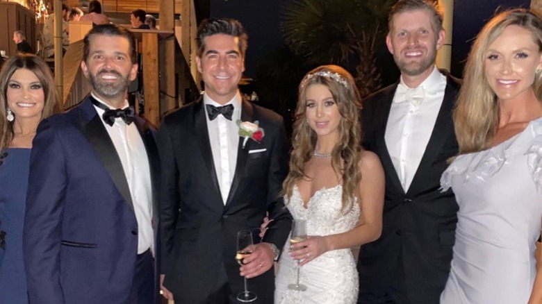 Jesse and Emma Watters posing with the Trump family on their wedding day