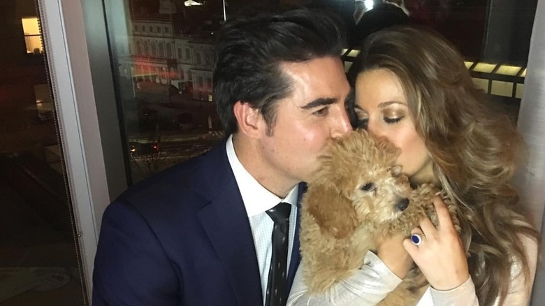 Jesse Watters and Emma Watters kissing their puppy Rookie