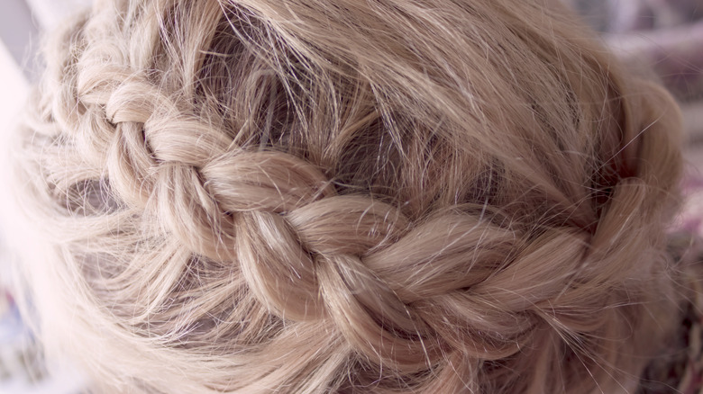 Blonde hair styled into a Dutch braid