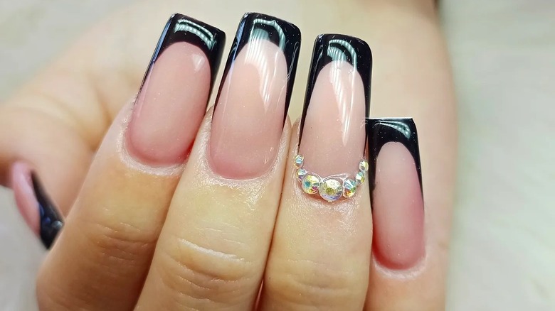 Elongated black French tips with rhinestones