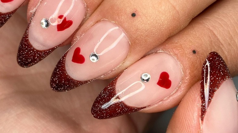 Red glitter tips with hearts and rhinestones