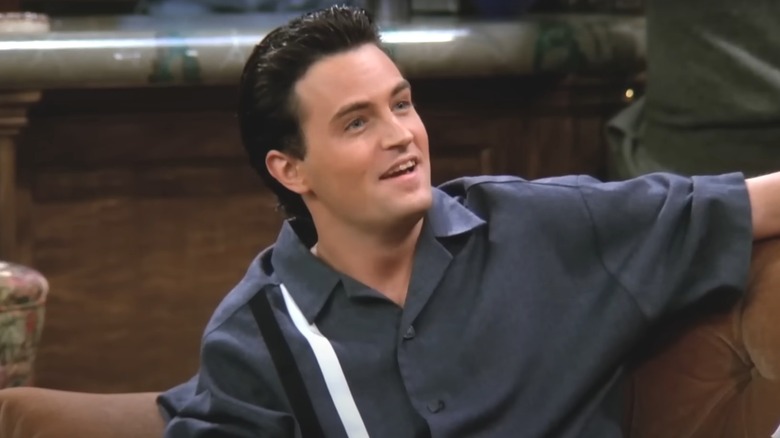 Matthew Perry smiling while performing in Friends 
