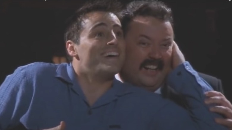 Matt LeBlanc and Mike Hagerty smiling while performing in Friends