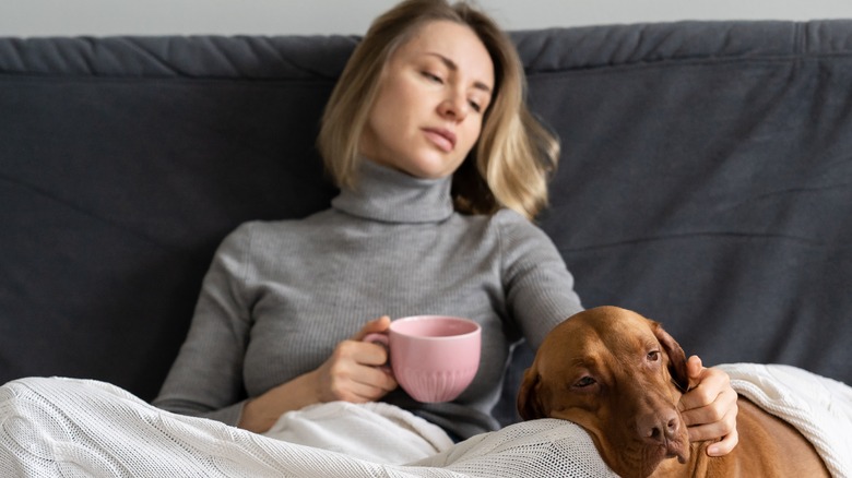 sad woman, dog on couch 