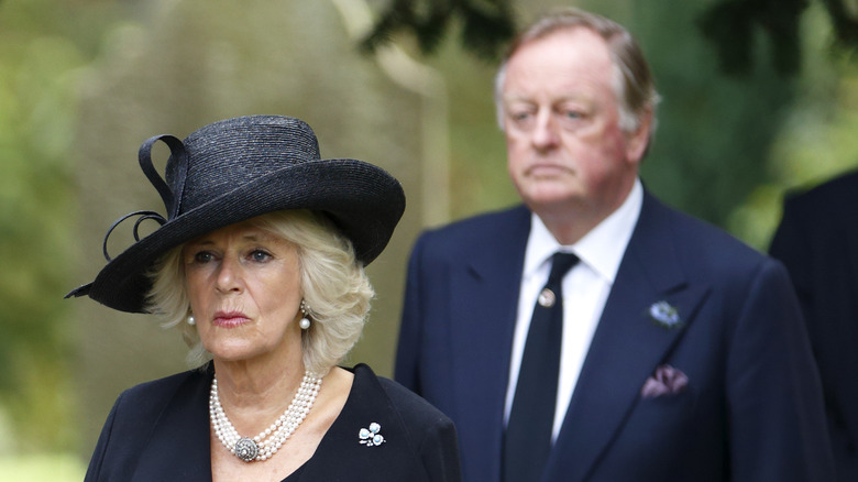 Andrew Parker Bowles walking behind Queen Camilla