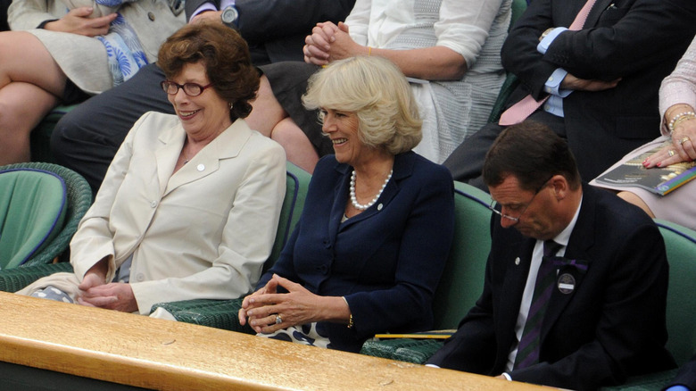 Queen Camilla and Lady Sarah Keswick sitting at event