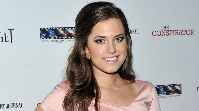 Allison Williams smiling in pink dress