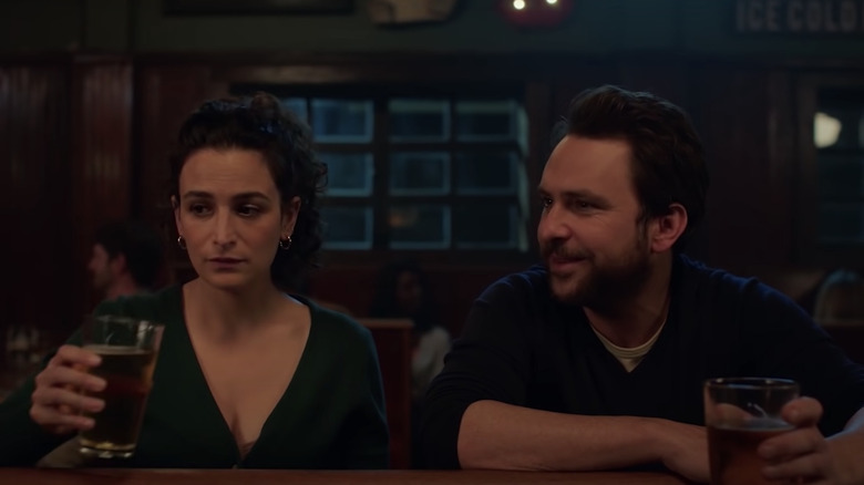 Jenny Slate and Charlie Day drinking beers