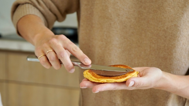 Claire Holt spreading Nutella on a pancake