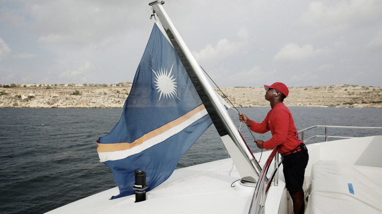 Mzi "Zee" Dempers raising a flag on "Below Deck Mediterranean" Season 7