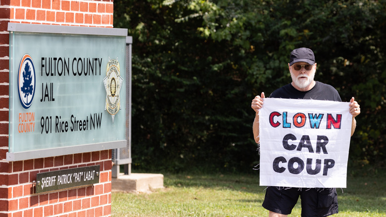 protestor stands outside fulton county jail