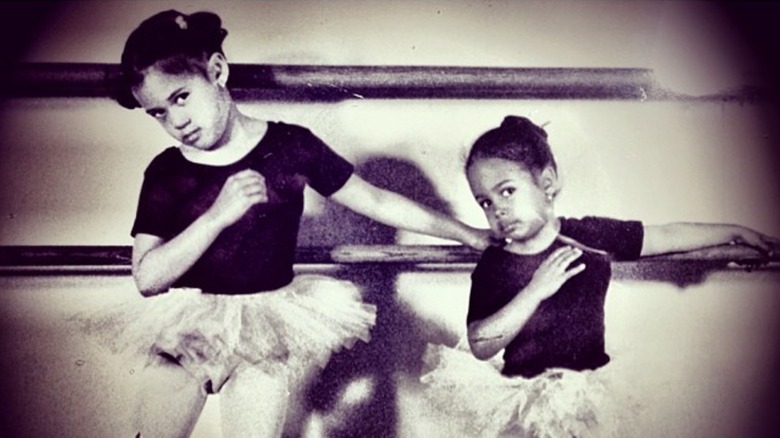 Kamala Harris and her sister posing against a ballet bar