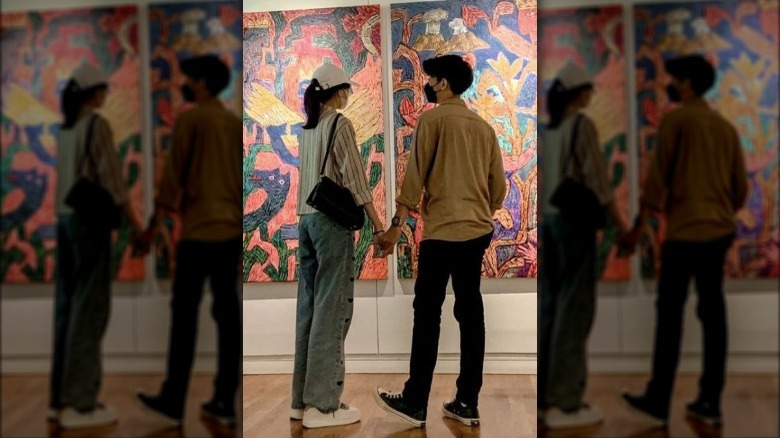 Couple holding hands at museum