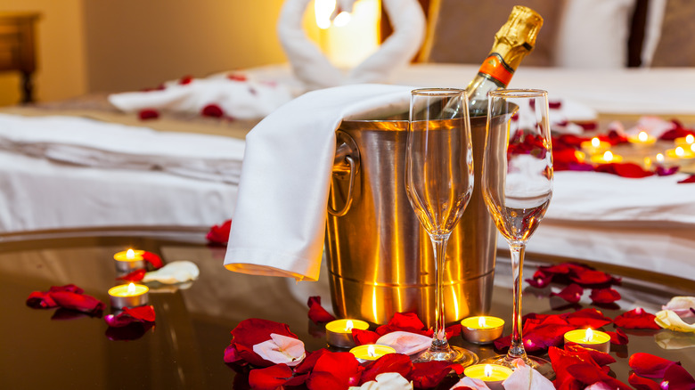 Rose petals and champagne in hotel room