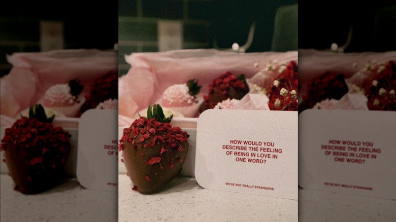 Card from game and chocolate-covered strawberries