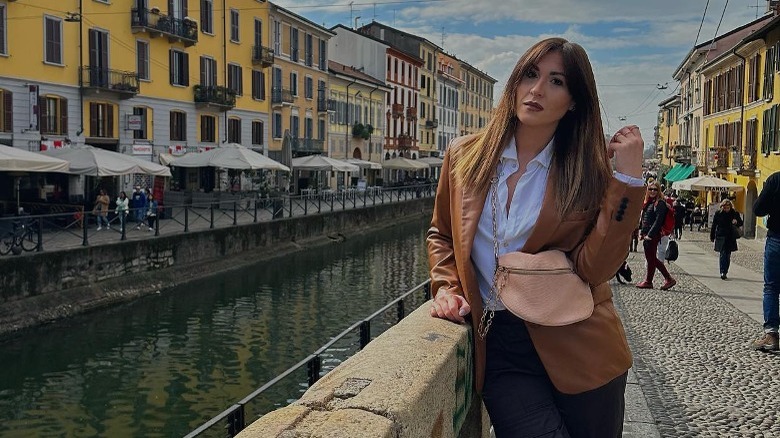 woman in leather blazer with crossbody bag