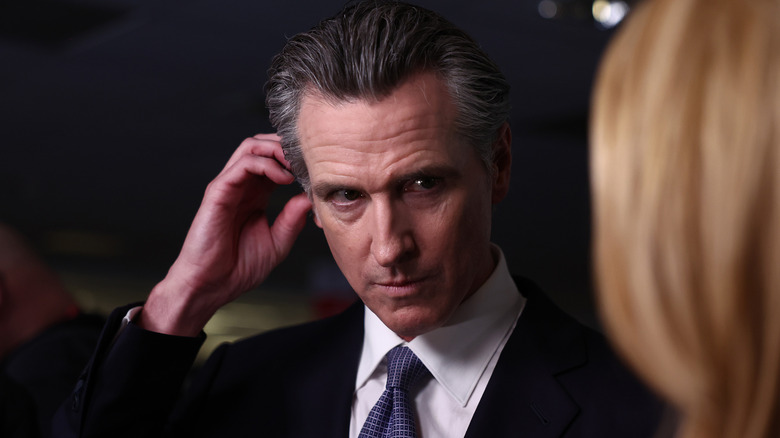 Gavin Newsom scratching his ear