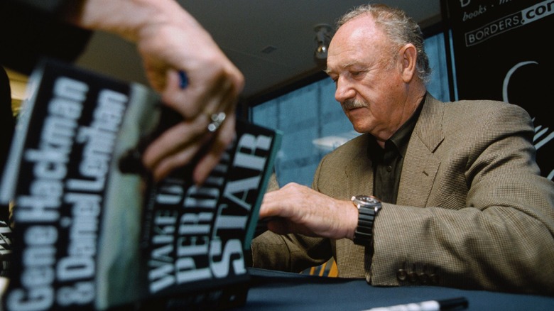 Gene Hackman signing a book