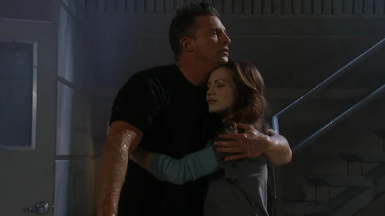 Jason holding Elizabeth in the rain