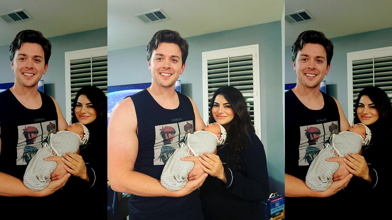 Chad Duell and Luana Lucci holding their newborn and smiling