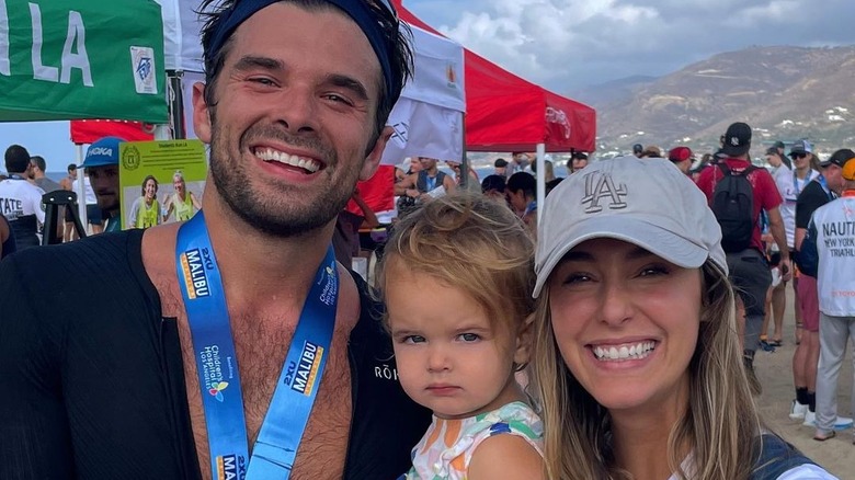 Josh Swickard and family smiling after triathlon