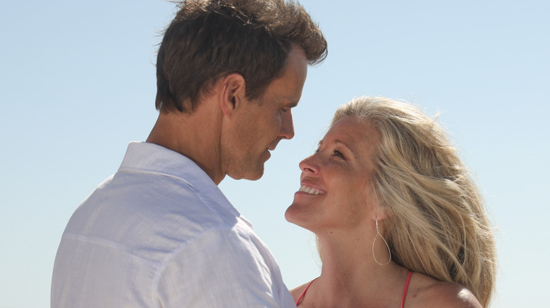 Drew and Carly gazing into each others' eyes at the beach