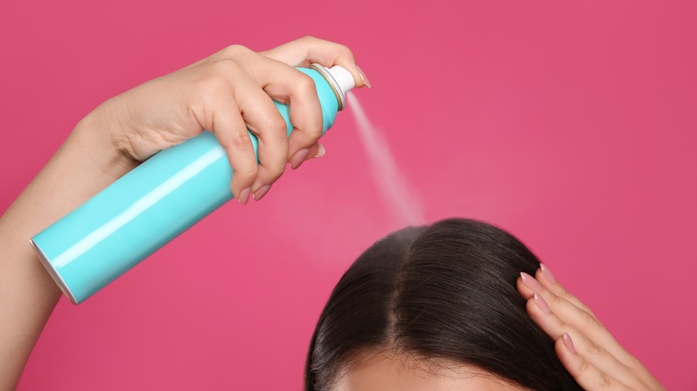 Woman applying dry shampoo