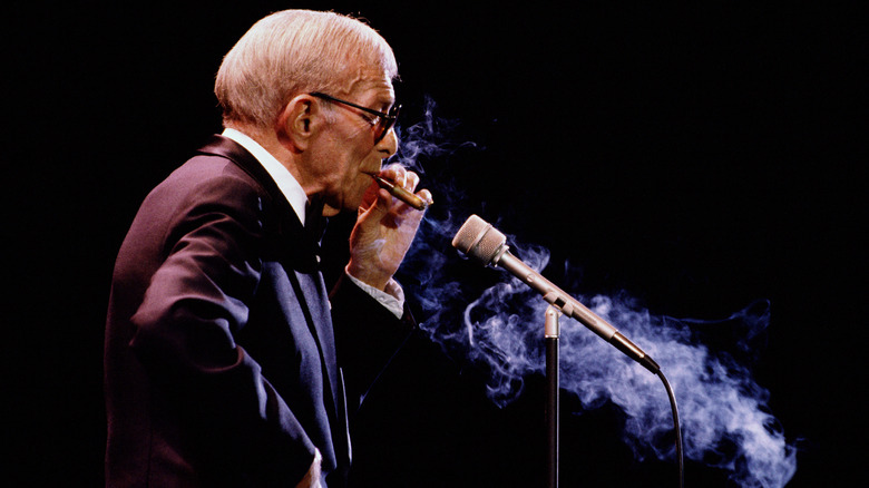 George Burns smoking a cigar on stage