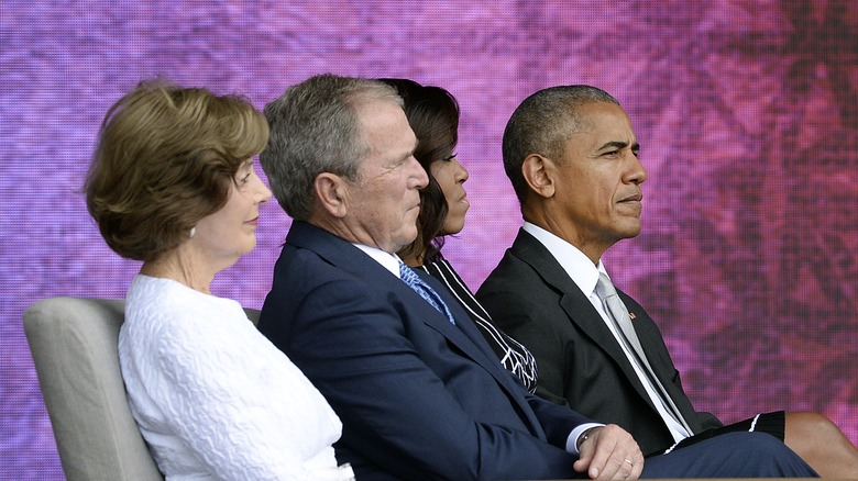 George W Bush sitting by Michelle Obama