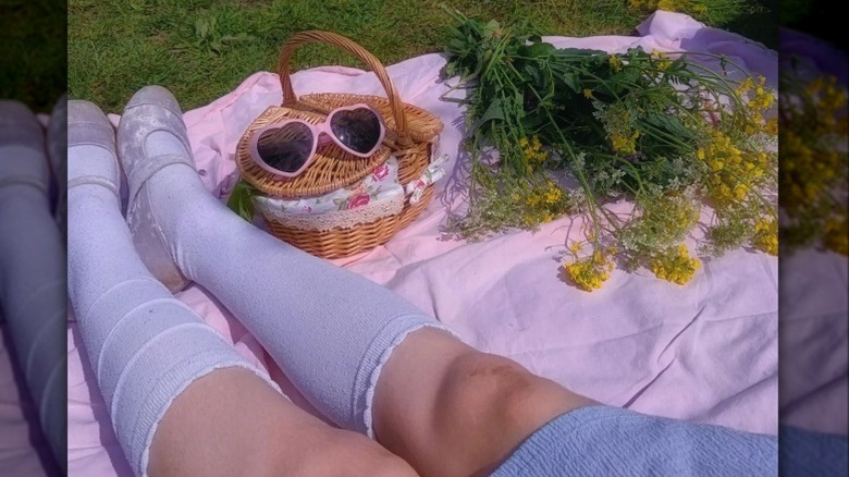 legs with knee socks resting on blanket