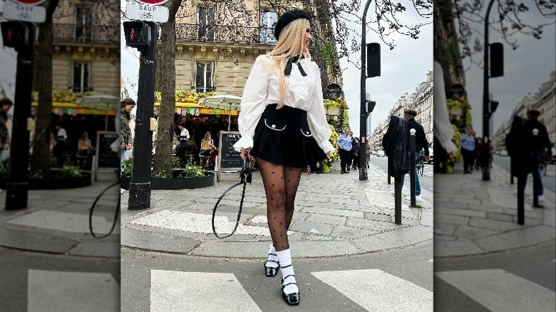 Woman in skirt and tights with Mary Janes