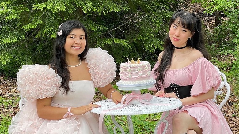 Women smiling in puffy-sleeved dresses