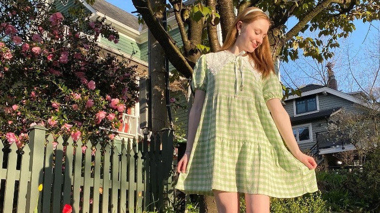 Woman wearing green checked dress