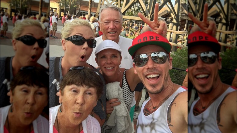 David Bromstad posing with his family at a theme park