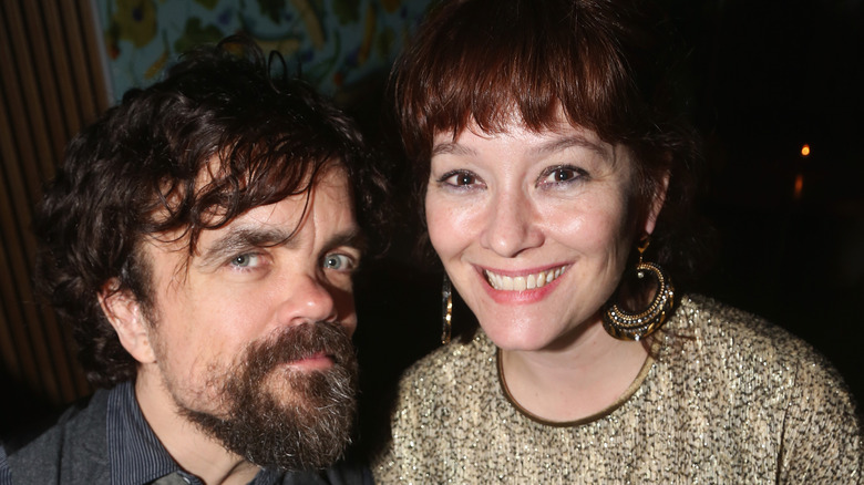 Peter Dinklage looking serious, Erica Schmidt smiling