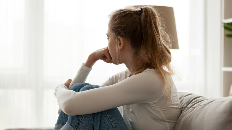 Woman looking out of window