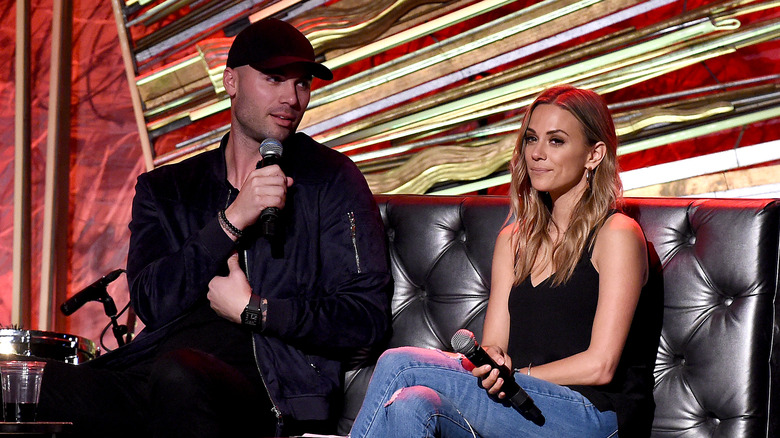 Mike Caussin and Jana Kramer holding microphones