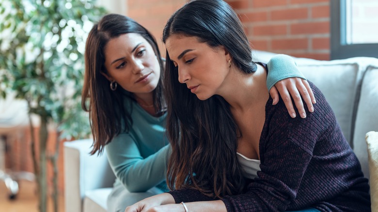 Woman comforting sad friend