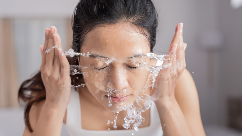 Woman washing her face