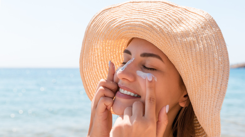 Woman putting on sunscreen