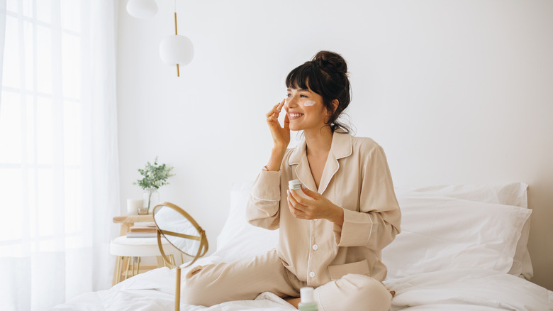 Woman applying skin cream